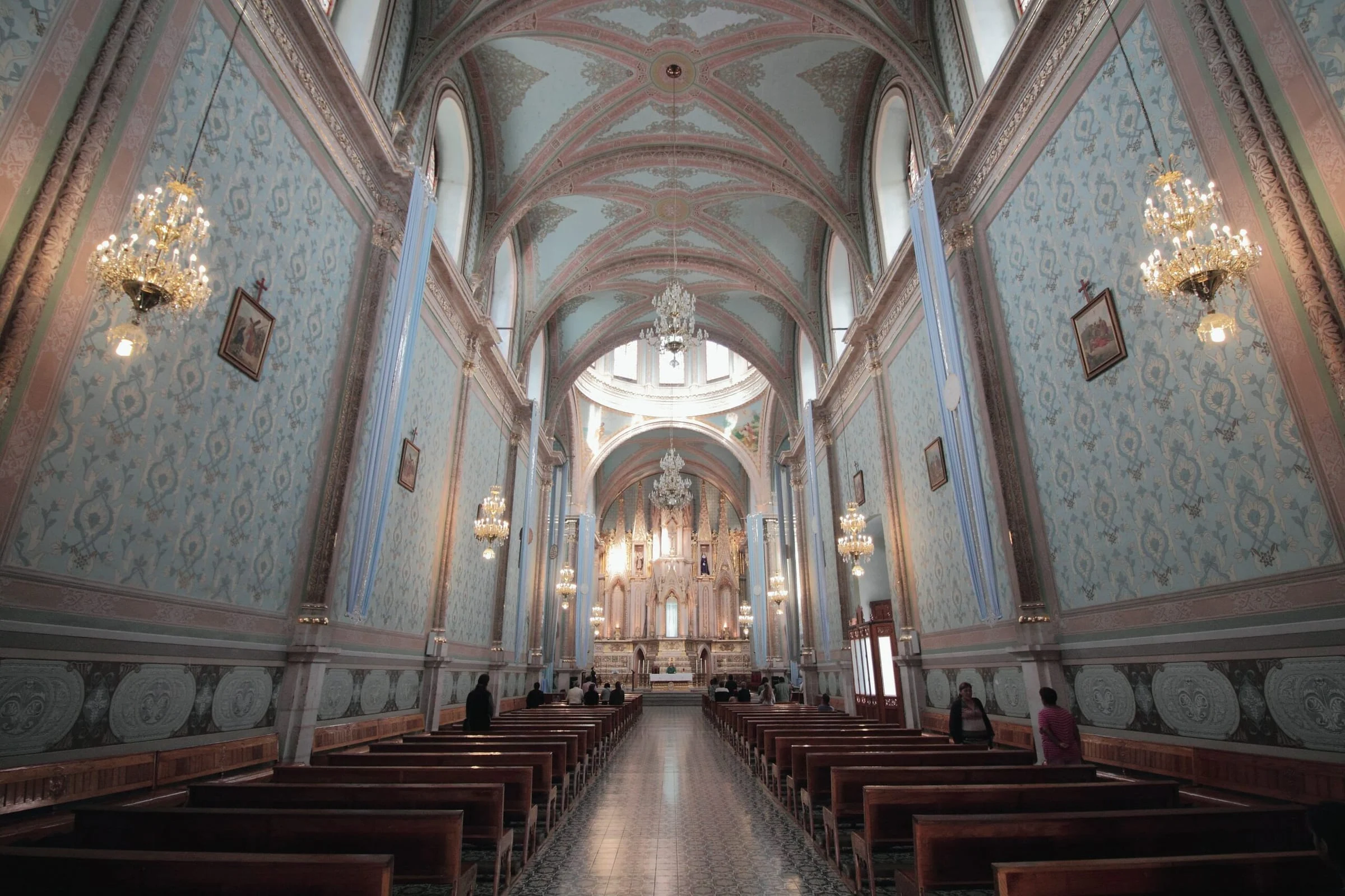 Interior of a church with pews and painted ceilings