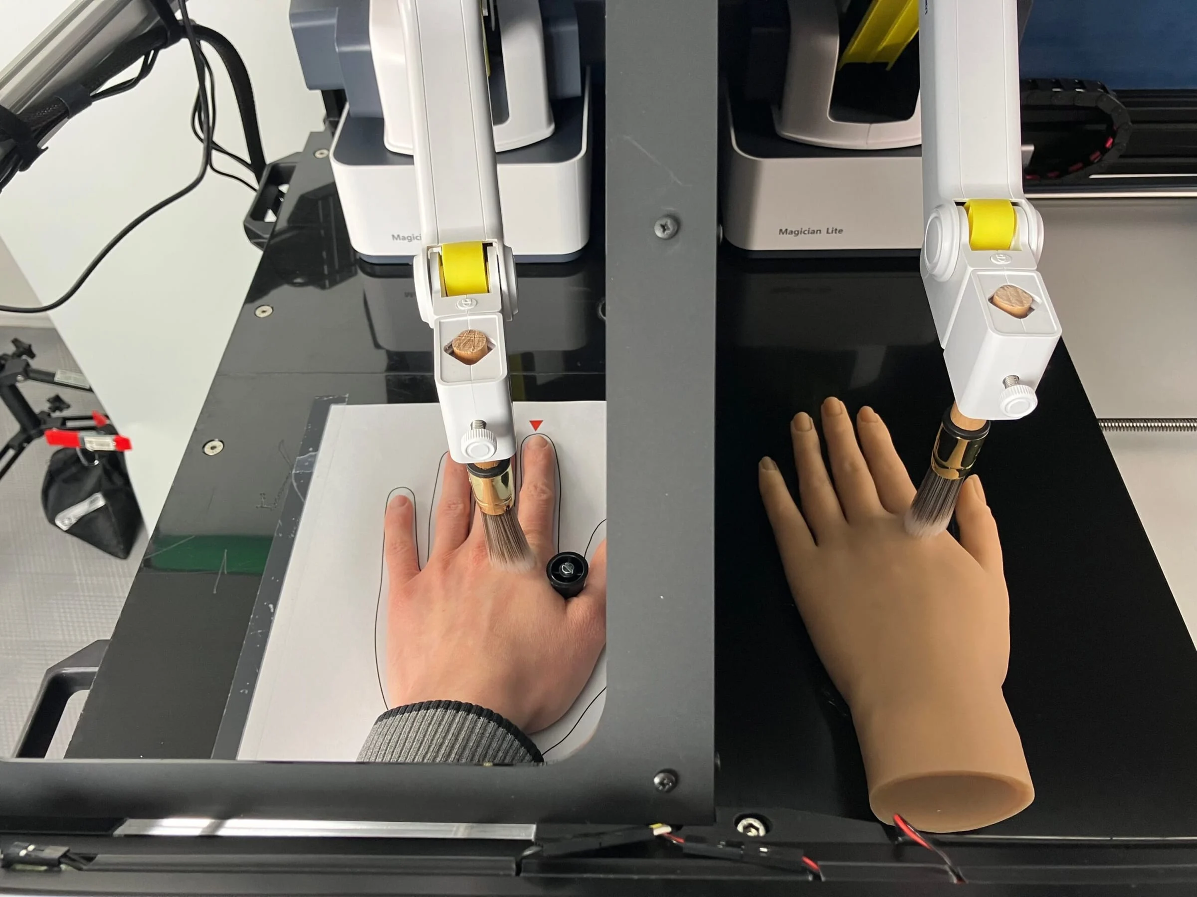 A participant’s real hand lying next to a rubber hand in a lab set-up